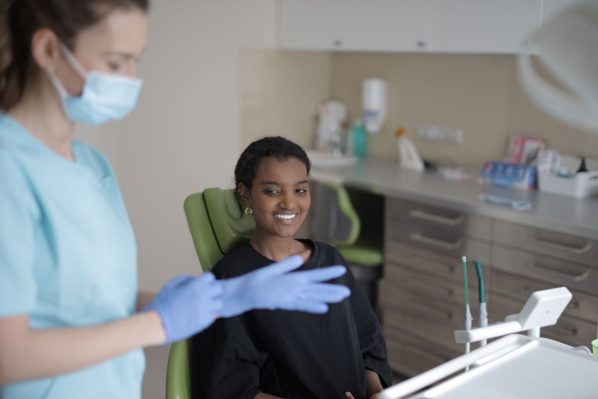 Receding gums Kharghar: smiling patient at a dental consultation at Samridhi Dental