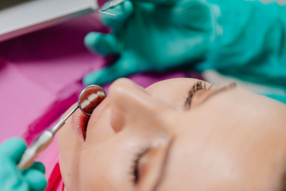 Close-up of a dental examination with mirror and instruments