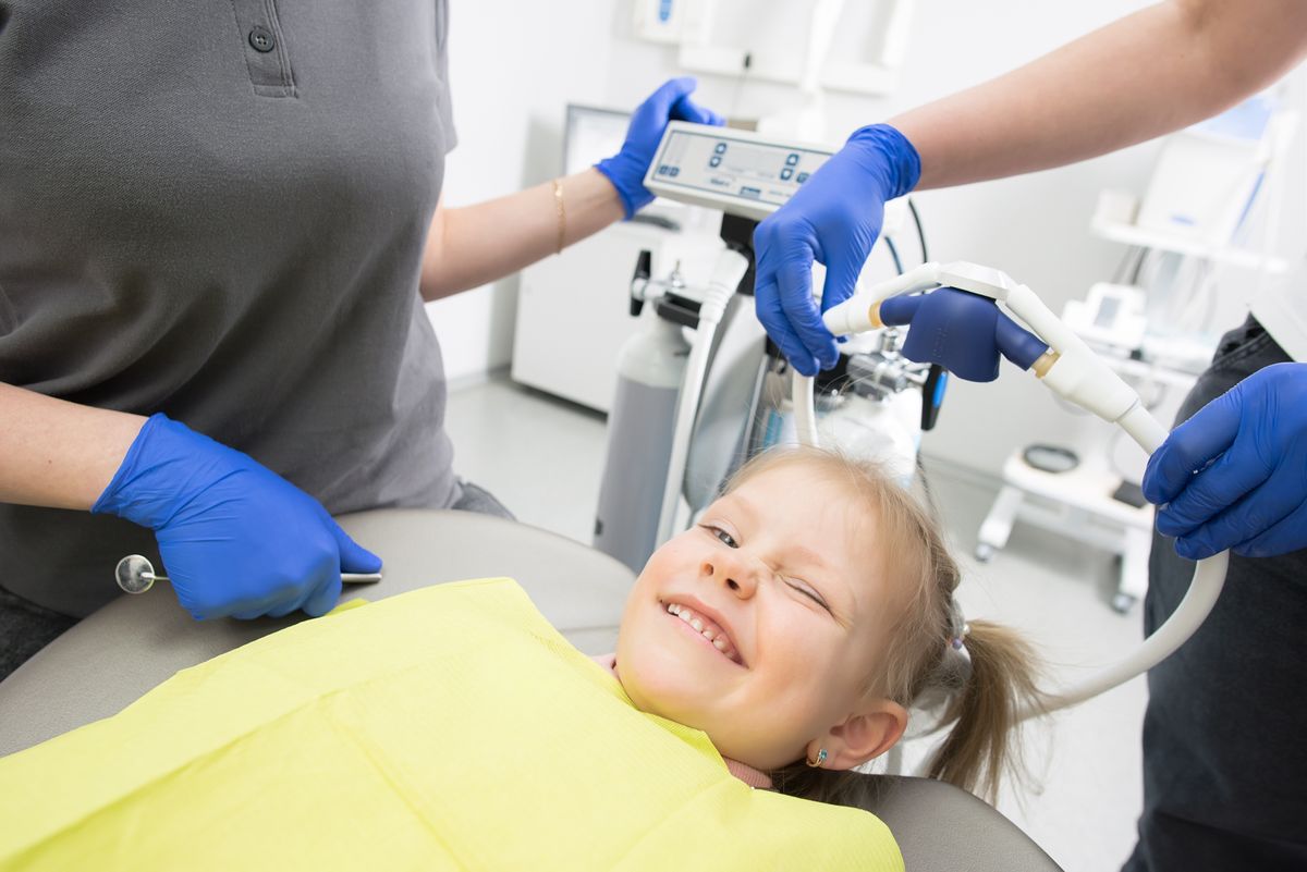 A cheerful child in a dental chair during a friendly check-up