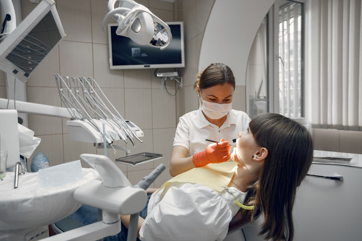 Dentist performing a careful procedure on a patient in a modern clinic